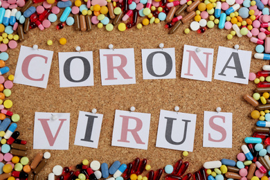 Photo of Flat lay composition with words CORONA VIRUS and medicine on corkboard