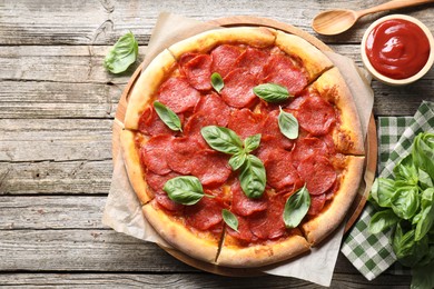 Flat lay composition with tasty pepperoni pizza on wooden table