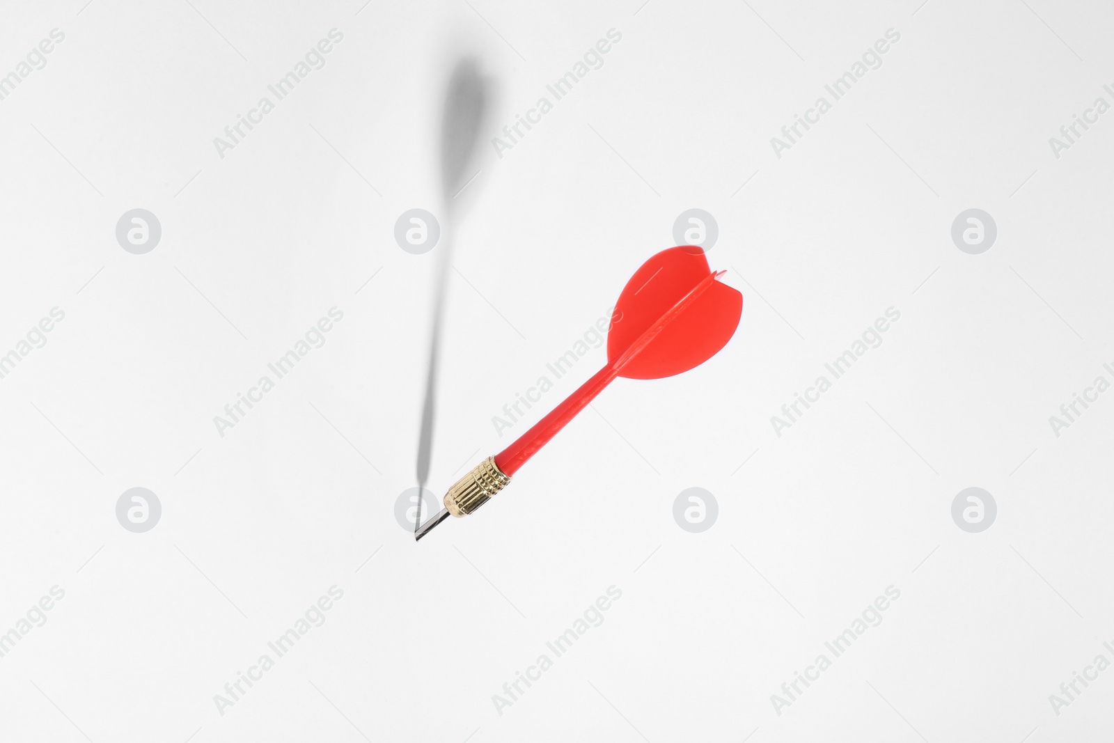 Photo of Red dart arrow for game on white background