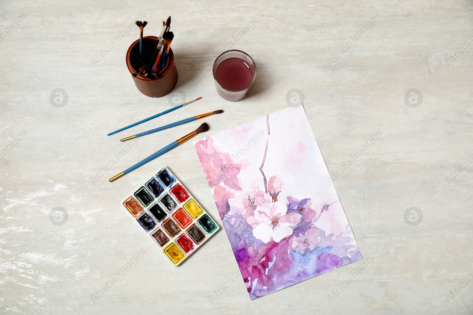 Photo of Flat lay composition with watercolor paints and floral picture on light table