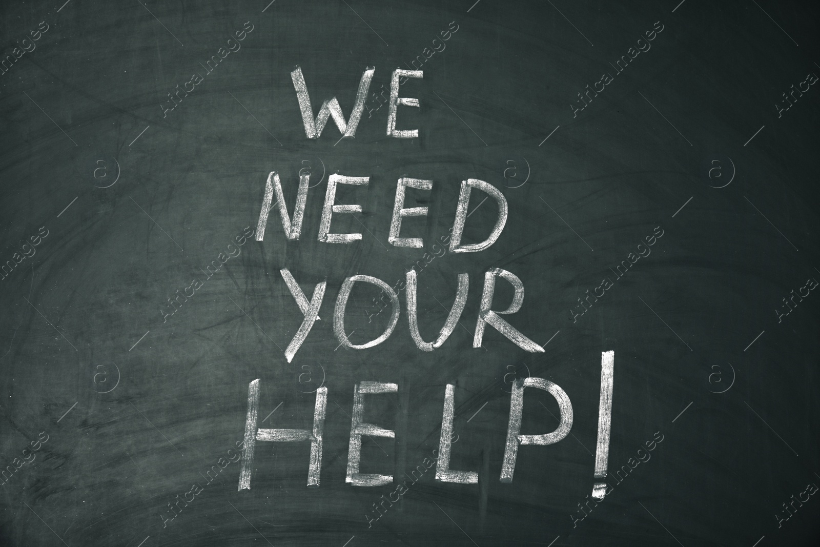 Photo of Phrase "We need your help" written on chalkboard