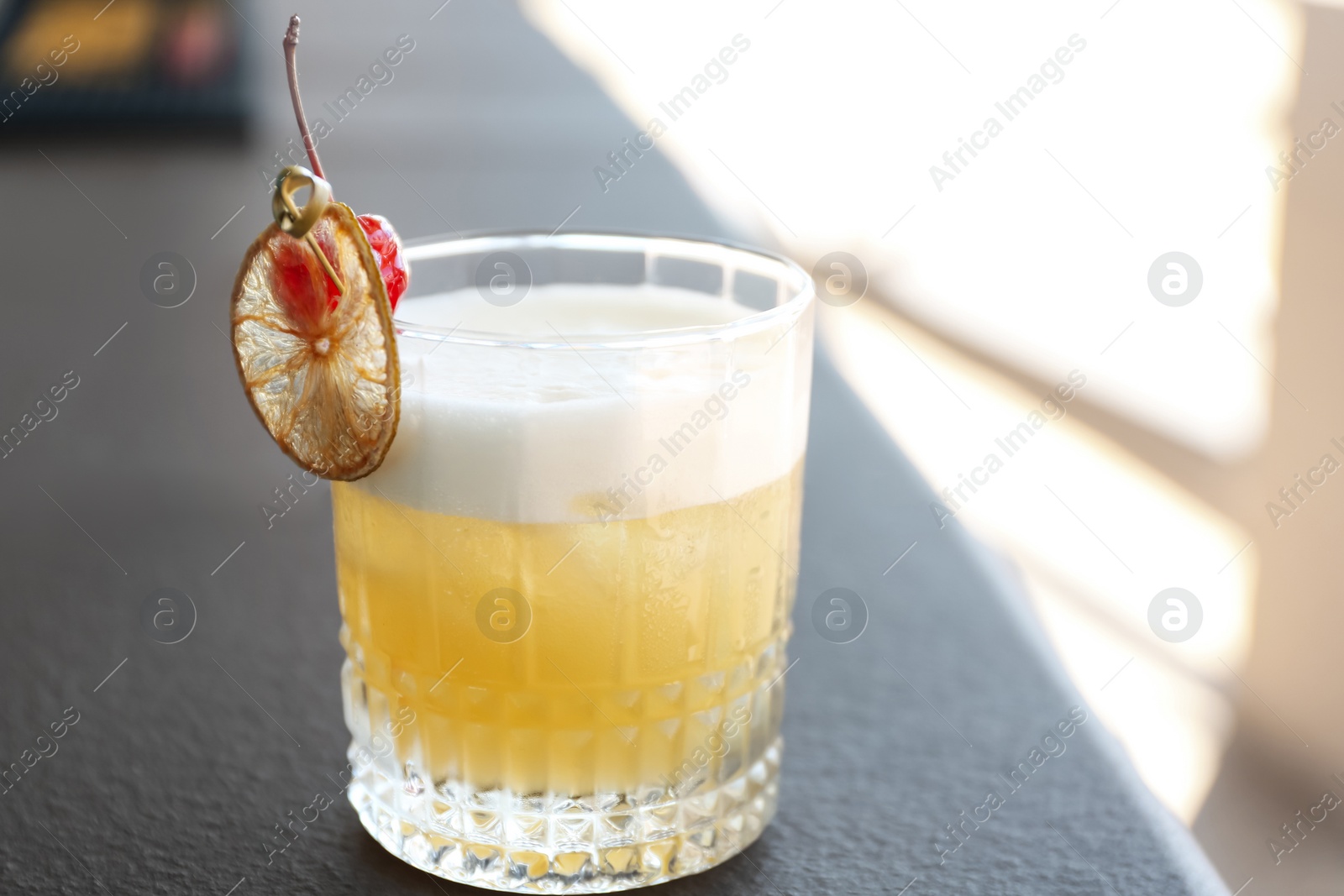 Photo of Delicious cocktail on table outdoors. Refreshing drink