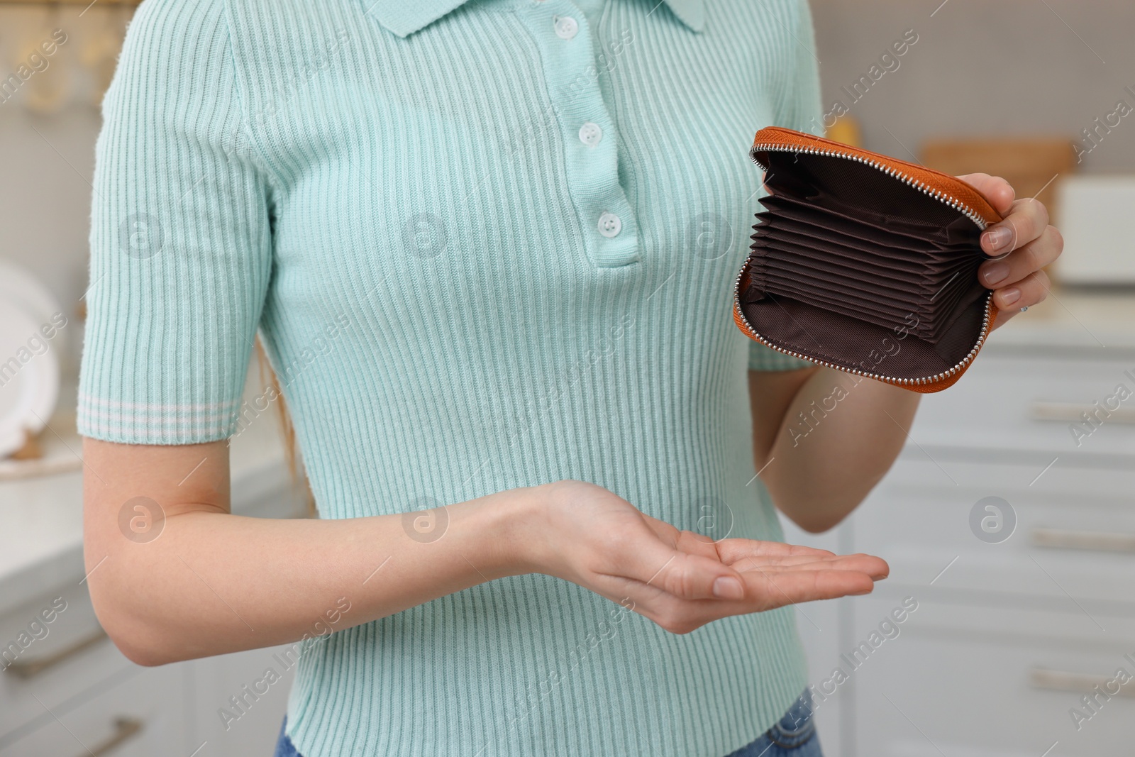 Photo of Woman with empty wallet at home, closeup