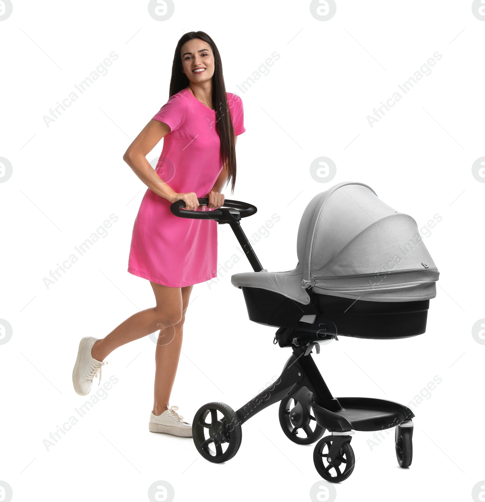 Photo of Happy young woman with baby stroller on white background