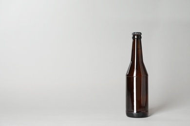 Bottle of beer on grey background. Space for text
