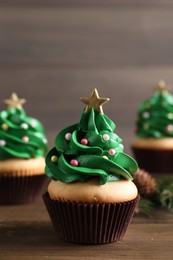 Christmas tree shaped cupcakes on wooden table