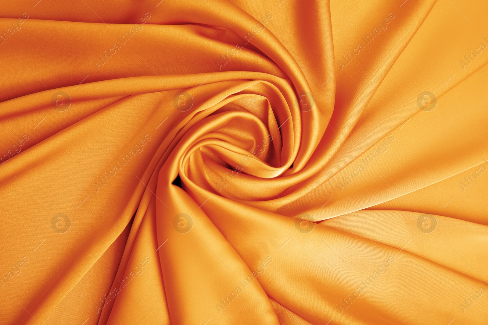 Image of Delicate orange silk fabric as background, top view