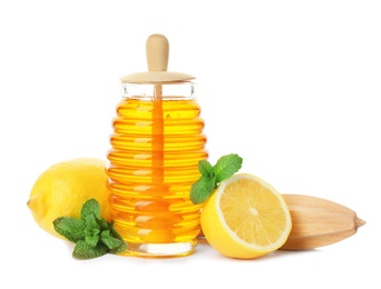 Photo of Jar of honey, mint, lemons and juicer on white background. Cough remedies
