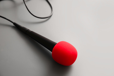 Microphone on light grey background. Journalist's work