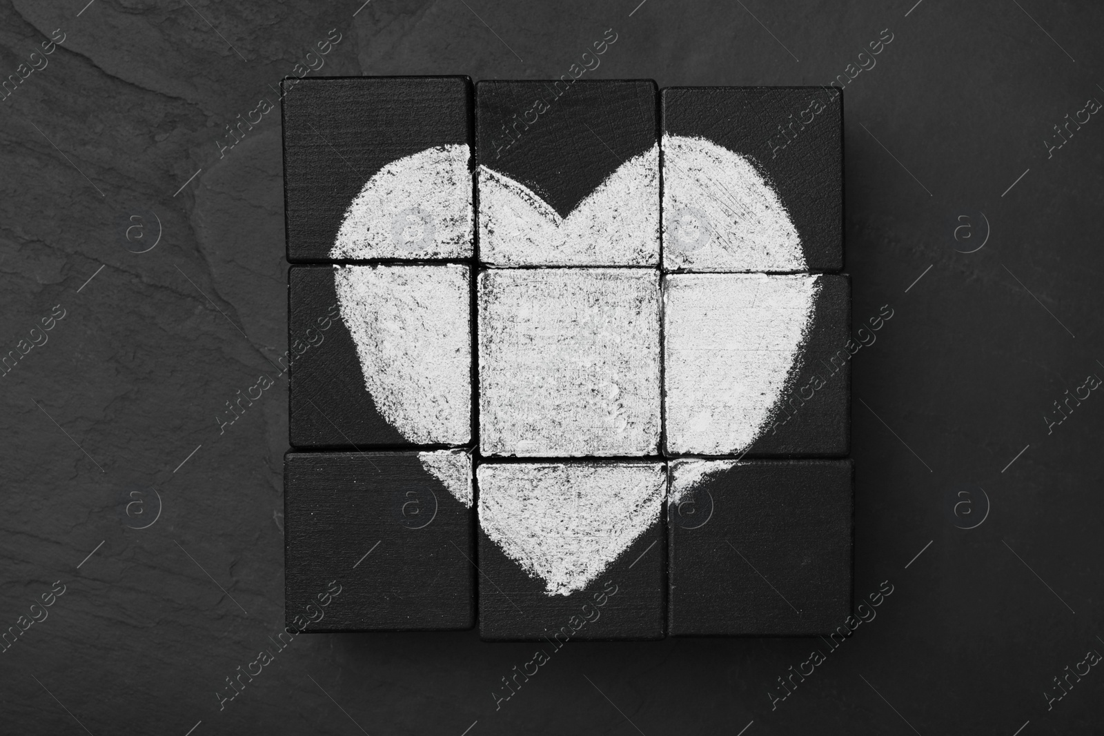 Photo of Heart drawn on black cubes, flat lay. Composition symbolizing problems in relationship