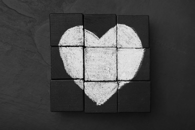 Photo of Heart drawn on black cubes, flat lay. Composition symbolizing problems in relationship