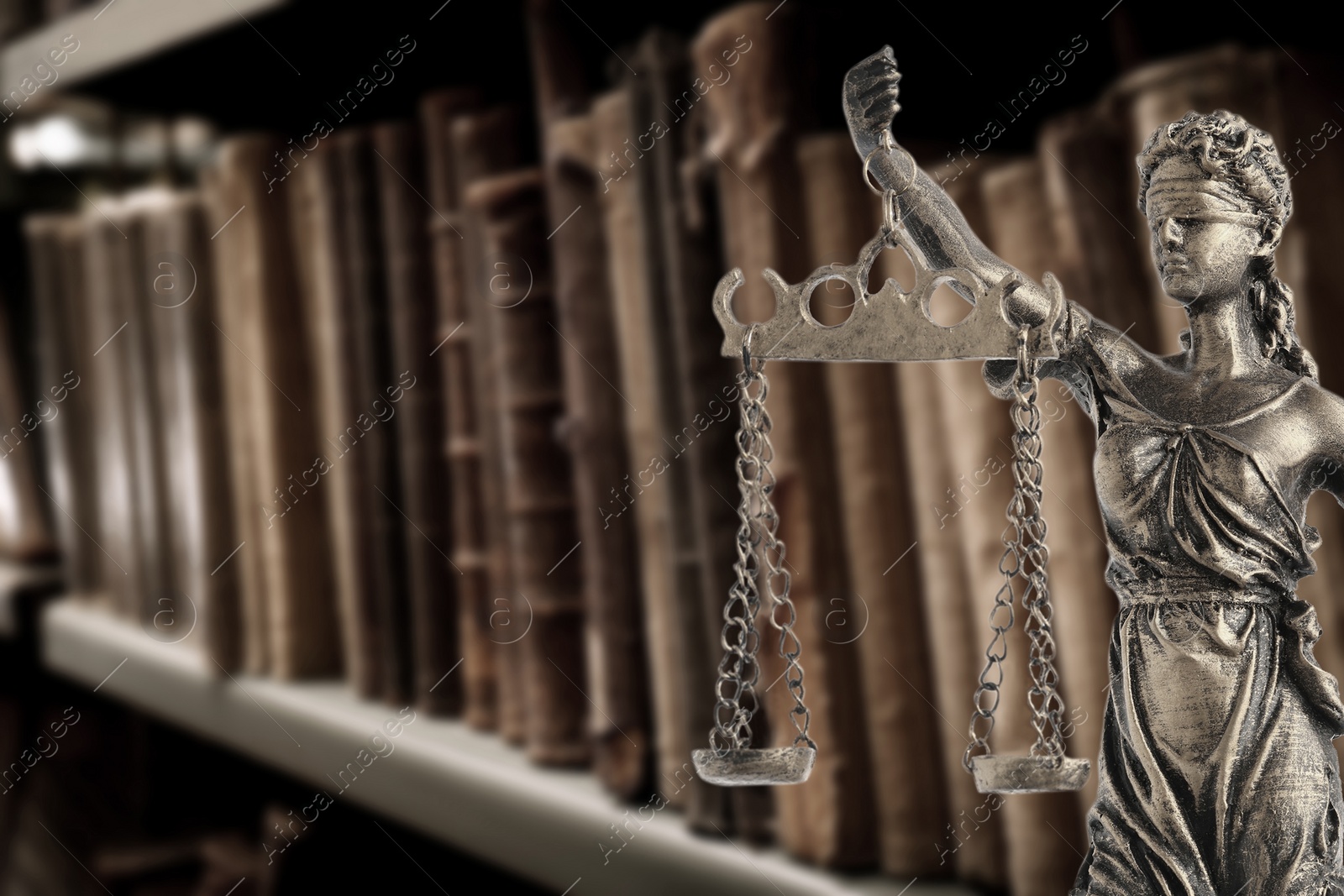 Image of Law and wisdom. Statue of Lady Justice near shelves with books, space for text