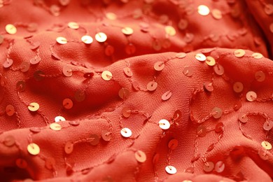 Beautiful red cloth with sequins as background, closeup