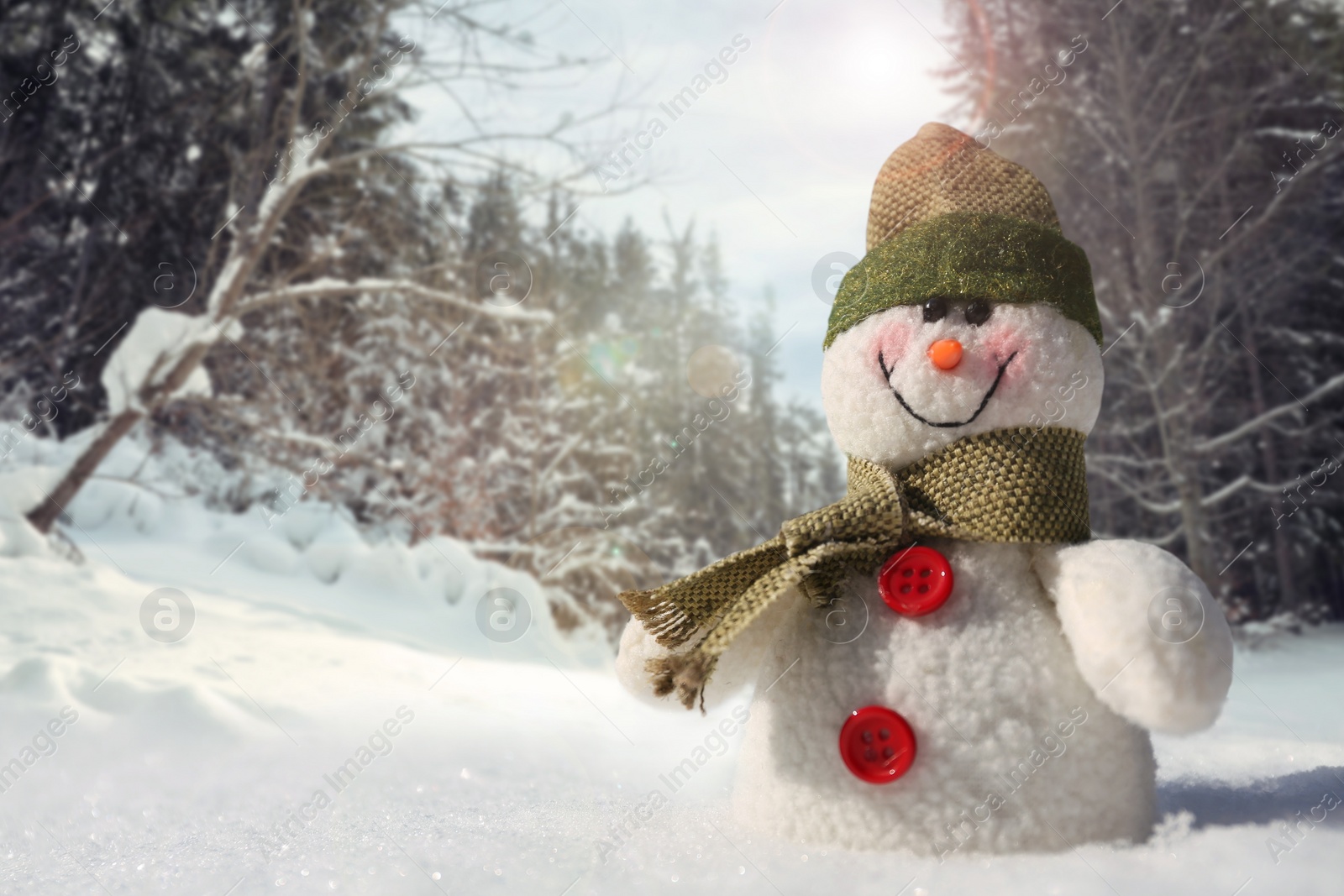 Image of Cute small decorative snowman outdoors on sunny day, space for text