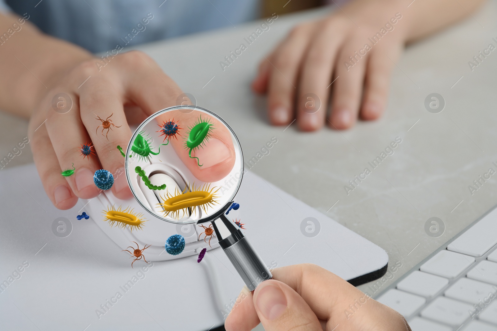 Image of Woman with magnifying glass detecting microbes on computer mouse, closeup