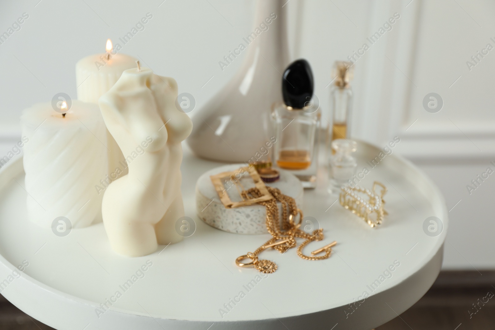 Photo of Beautiful female body shaped candle on white table. Stylish decor
