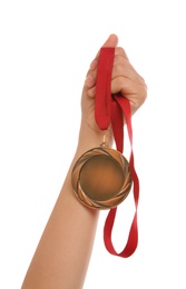 Woman holding bronze medal on white background, closeup