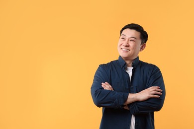 Photo of Portrait of happy man on yellow background. Space for text