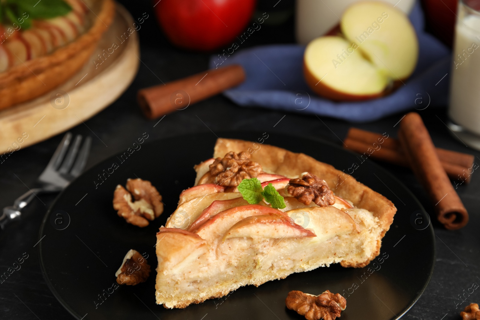 Photo of Slice of delicious apple pie on black table