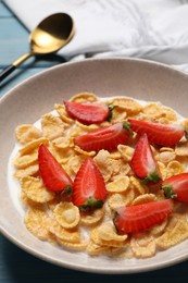 Photo of Delicious crispy cornflakes with milk and fresh strawberries on table, closeup
