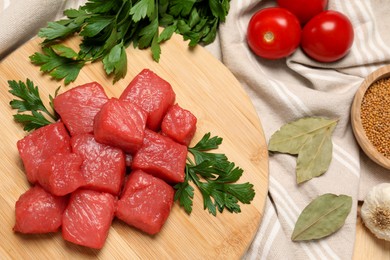 Photo of Raw beef meat and different ingredients for cooking delicious goulash on table, flat lay