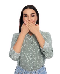 Embarrassed young woman covering mouth with hands on white background