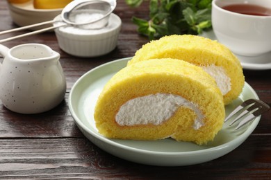 Photo of Delicious cake roll served on wooden table, closeup