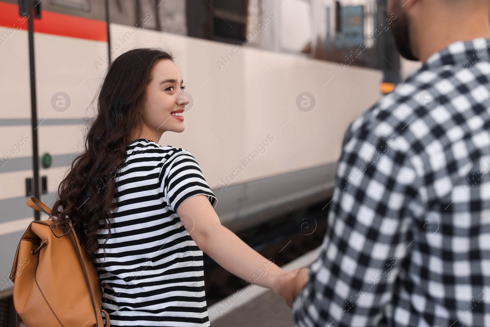 Photo of Long-distance relationship. Couple walking on platform of railway station