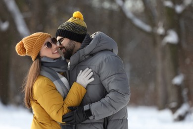 Beautiful happy couple outdoors on winter day. Space for text