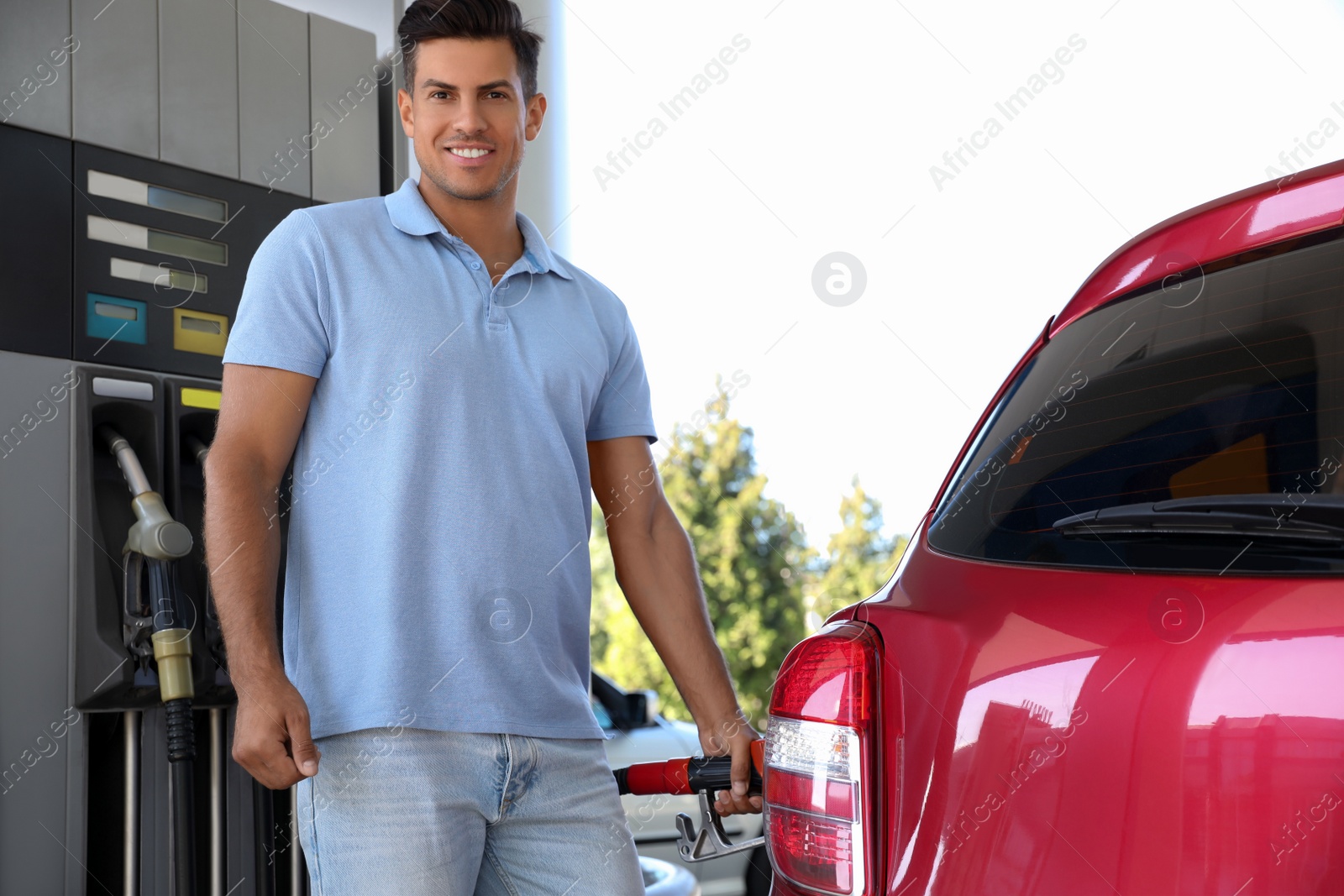 Photo of Man refueling car at self service gas station