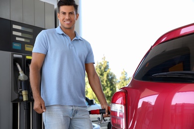 Man refueling car at self service gas station