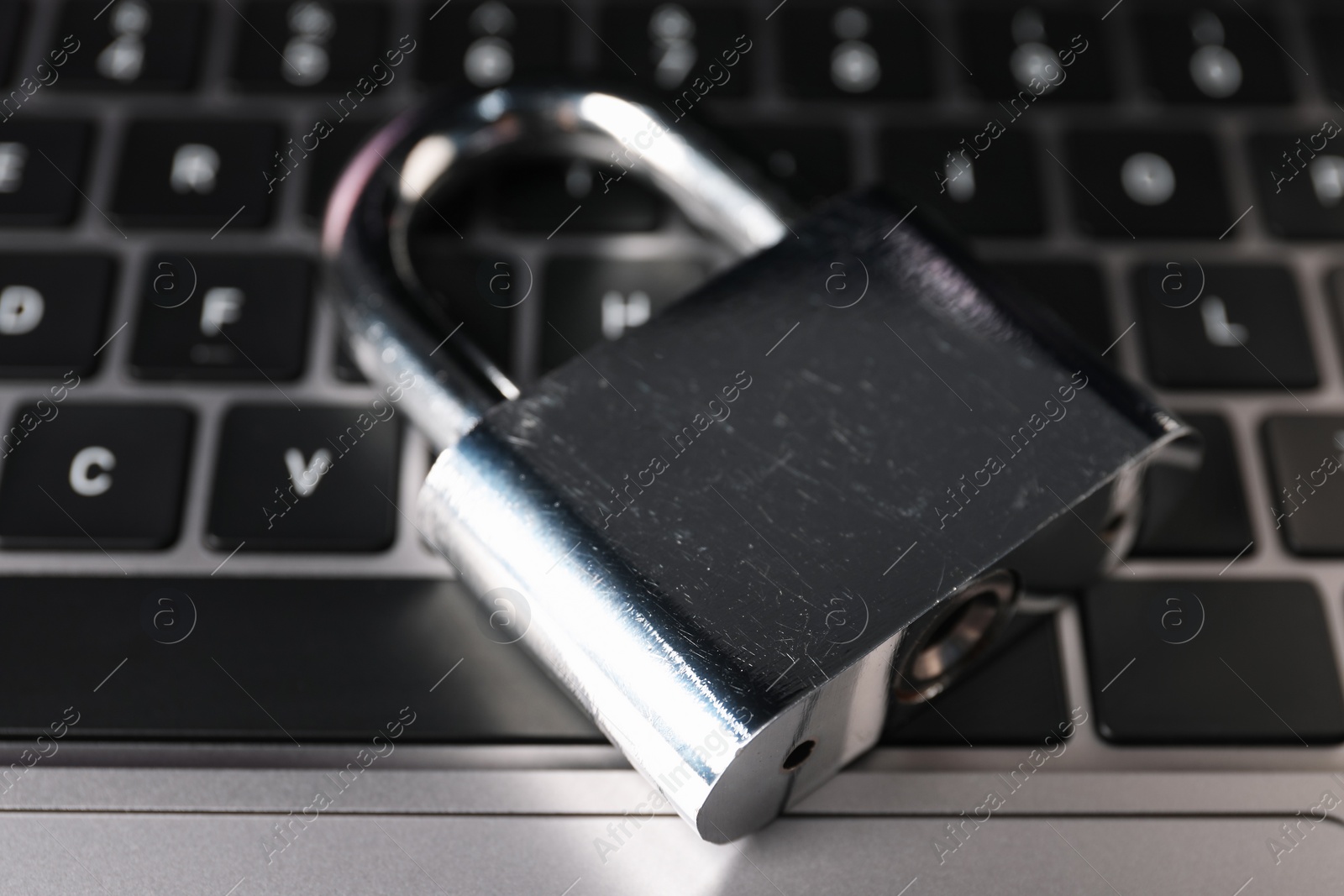 Photo of Cyber security. Padlock on laptop, closeup view