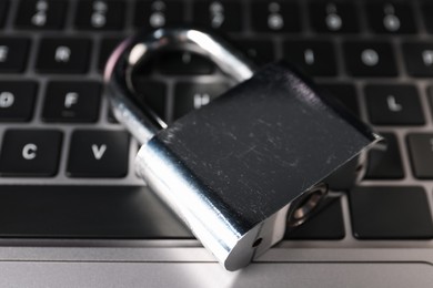 Photo of Cyber security. Padlock on laptop, closeup view