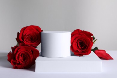 Stylish presentation for product. Beautiful red roses and geometric figures on light background