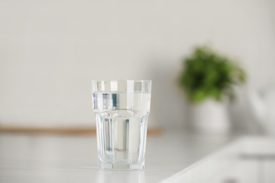 Photo of Glass of pure water on table indoors