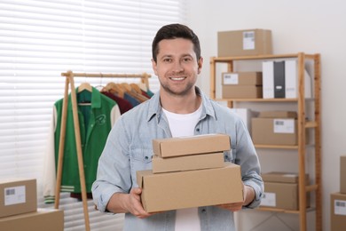 Photo of Seller with parcels in office. Online store