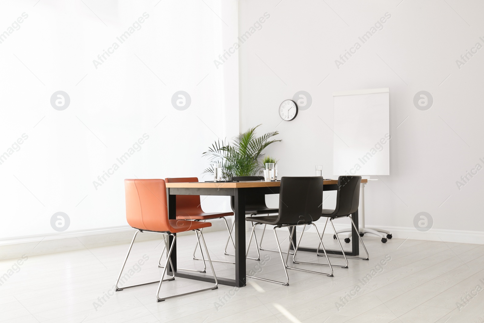 Photo of Simple office interior with large table and chairs