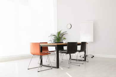 Simple office interior with large table and chairs