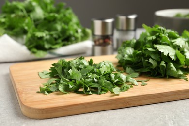 Photo of Fresh green  cilantro on light grey table, closeup