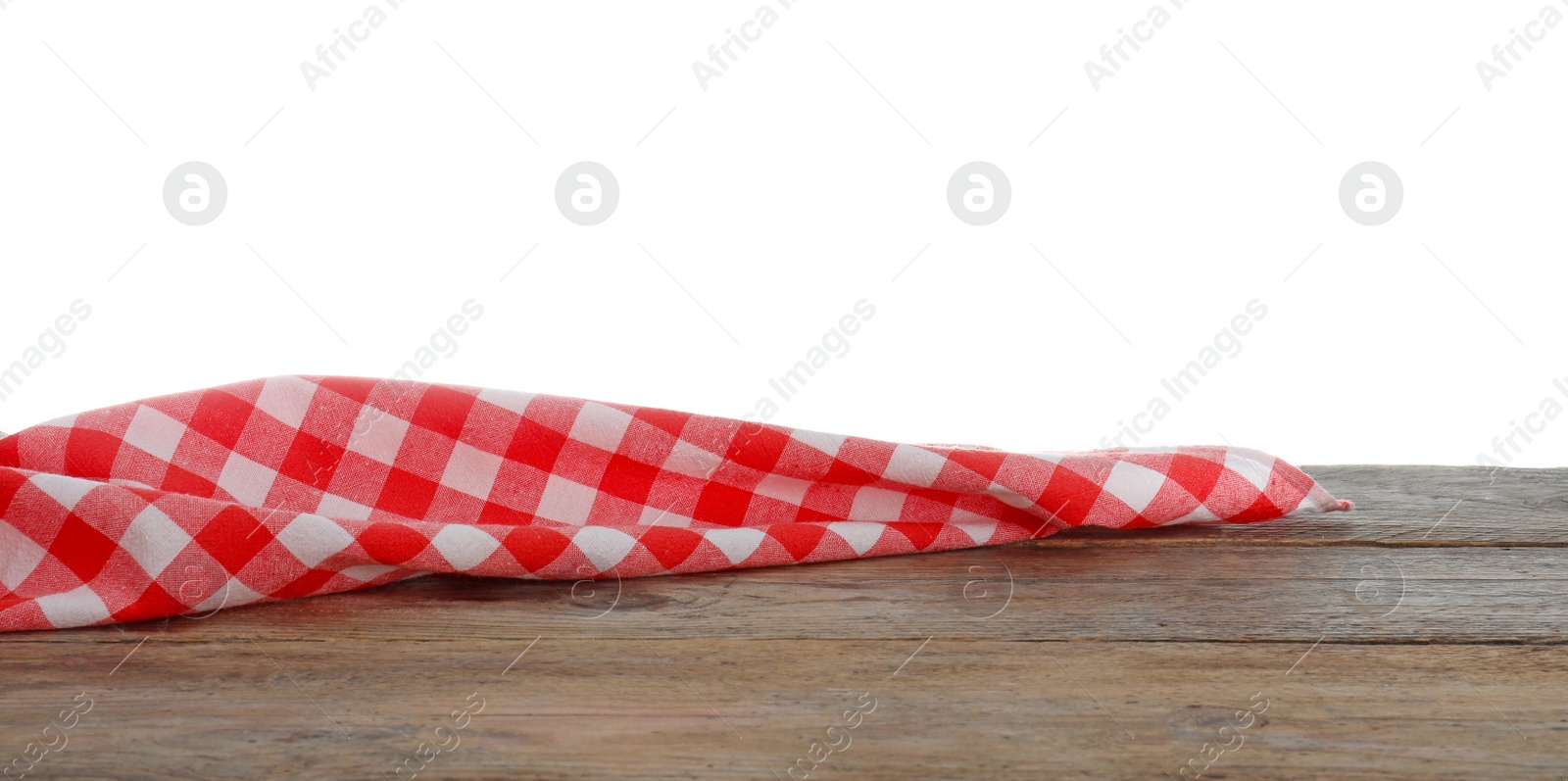 Photo of Red checkered cloth on wooden table against white background. Mockup for design