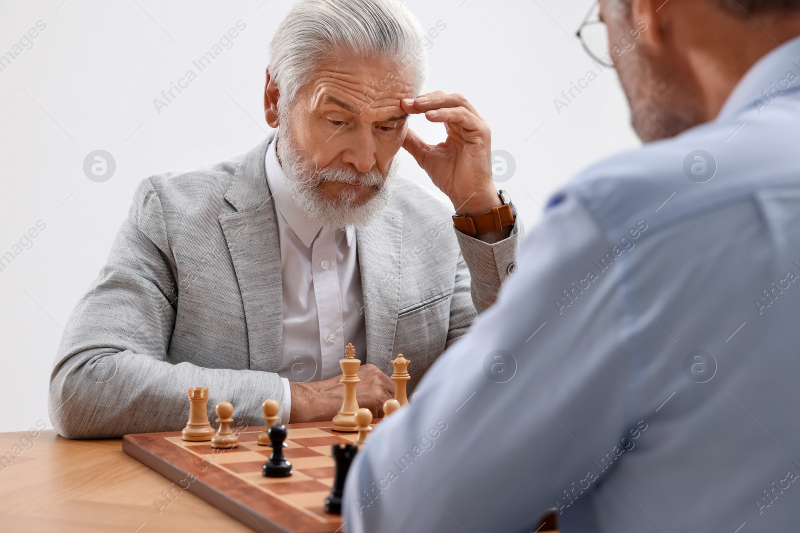 Photo of Men playing chess during tournament at table