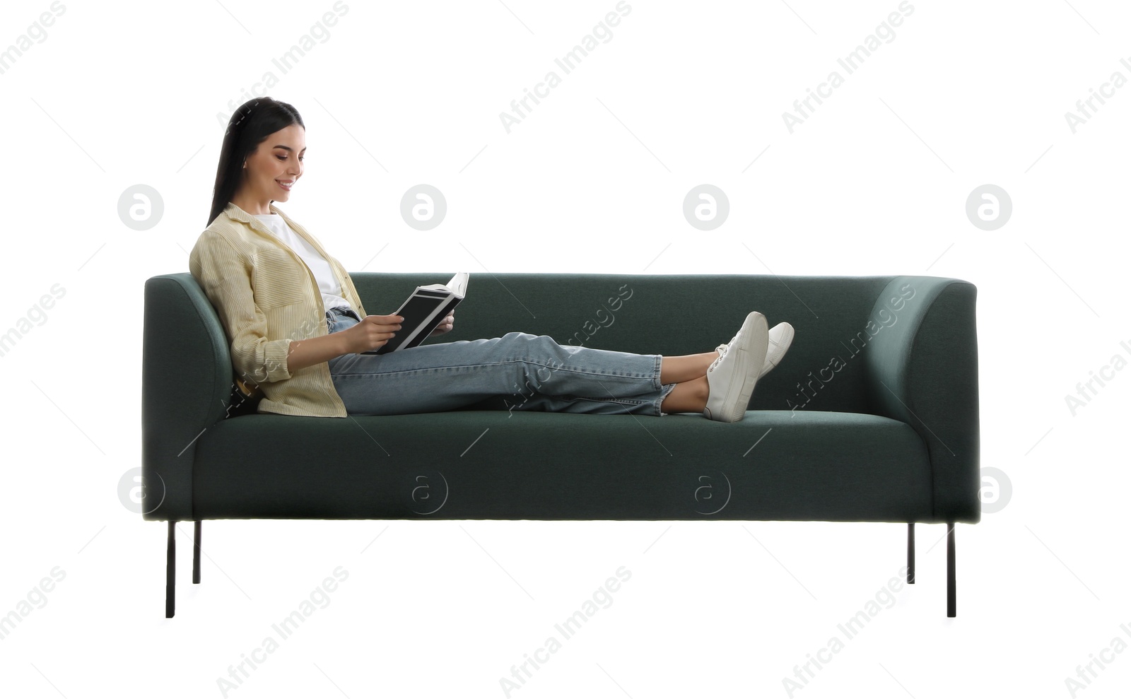 Photo of Young woman reading book on comfortable green sofa against white background