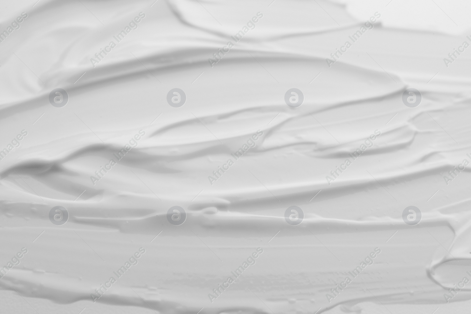 Photo of Samples of face cream as background, top view