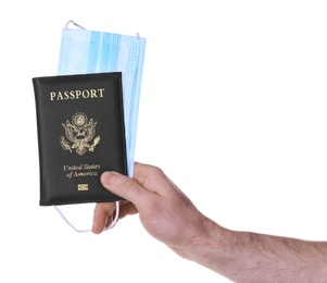 Man holding passport and protective mask on white background, closeup. Travel during quarantine