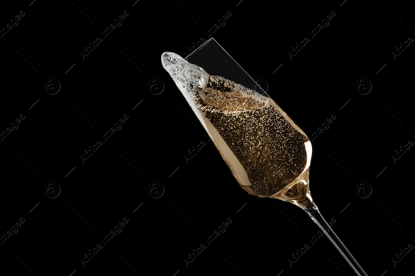 Photo of Glass of fizzy champagne on black background, closeup. Space for text