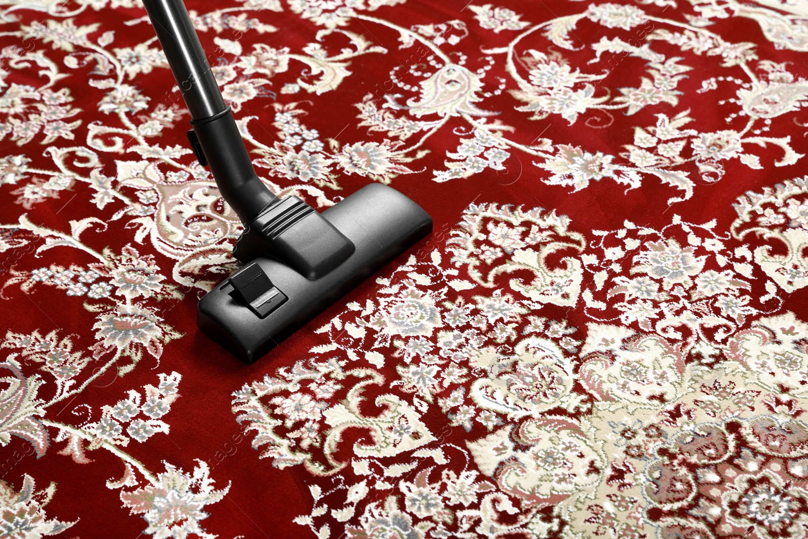 Photo of Removing dirt from carpet with modern vacuum cleaner. Space for text