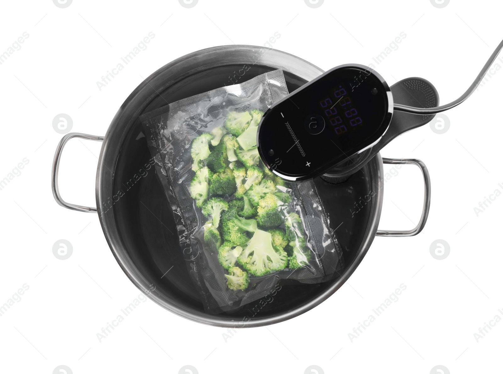 Photo of Thermal immersion circulator and vacuum packed broccoli in pot on white background, top view. Sous vide cooking