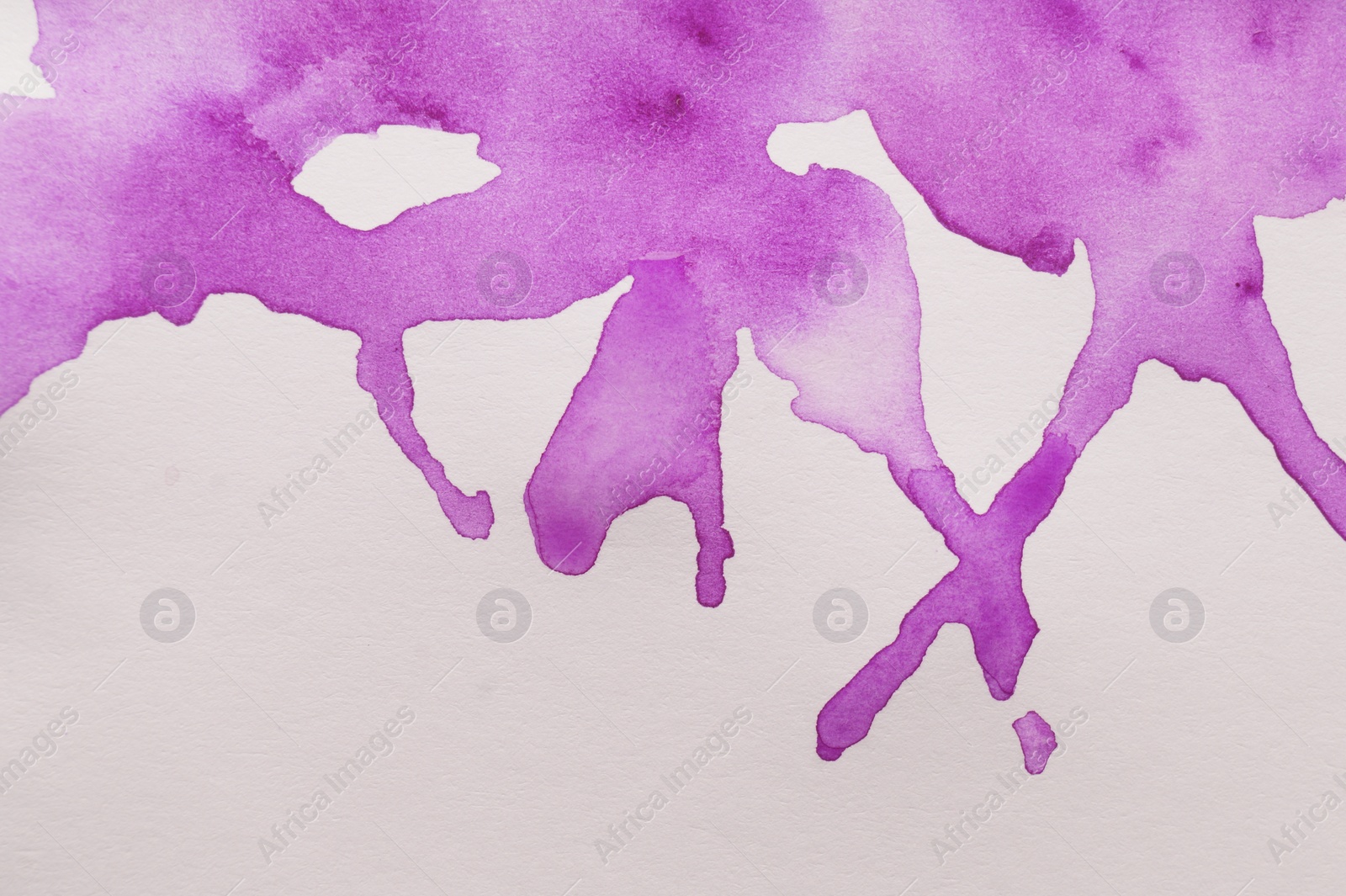Photo of Purple watercolor blots on white canvas, top view. Space for text
