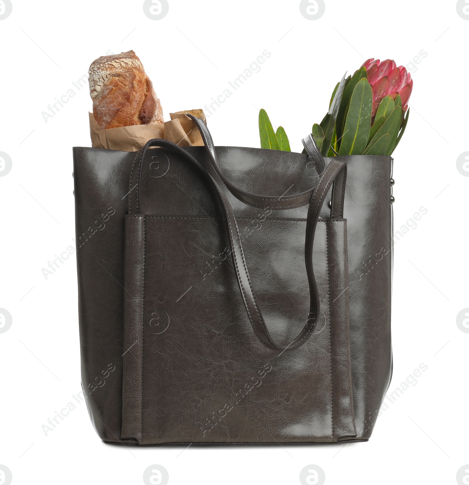 Photo of New leather shopper bag with purchases on white background