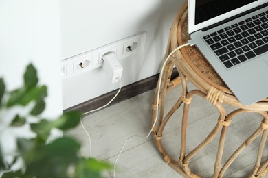 Electric power outlet sockets with charger on white wall